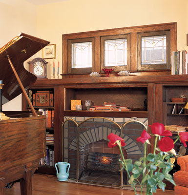 Decorative details such as the simple—but solid—wood frames around the stained glass windows in the living room represent an Arts and Crafts architectural style blended with the design influence of Frank Lloyd Wright.
